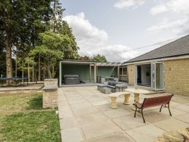 An outdoor space with a hot tub and seating area at Chillon in South Littleton near Honeybourne