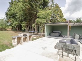 An outdoor area with a jacuzzi and seating at Chillon in South Littleton near Honeybourne