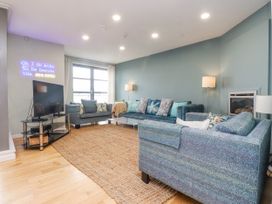 A living room with a sofa and television at 2 The Quay in Pentraeth