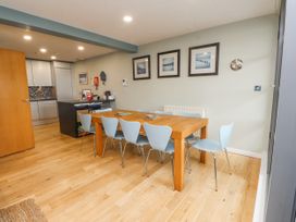 A dining area with a wooden table and chairs at 2 The Quay Pentraeth