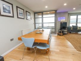 A dining room with a table and chairs at 2 The Quay in Pentraeth