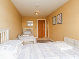 A bedroom with twin beds and wall art at 2 The Quay Pentraeth