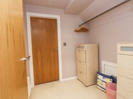 A closet with dressers and hangers at 2 The Quay, Pentraeth