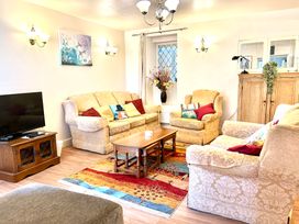 A living room with sofas and a coffee table at Garden Flat in Porthmadog