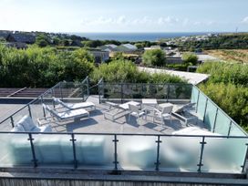 An outdoor terrace with seating and a view at The Black Barnacle in Portreath