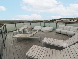 An outdoor terrace with seating and a table at The Black Barnacle in Portreath