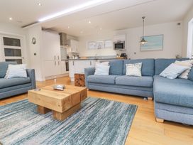 A living room with a sofa and coffee table at The Black Barnacle in Portreath