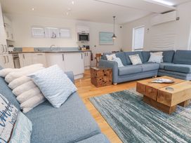 A living room with a couch and coffee table at The Black Barnacle in Portreath