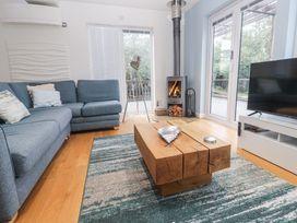 A living room with a fireplace and a coffee table at The Black Barnacle in Portreath