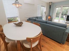 A living room with a dining table and sofa at The Black Barnacle in Portreath