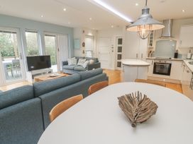 A living room with sofa and dining table at The Black Barnacle Portreath