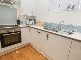 A kitchen with a sink and oven at The Black Barnacle in Portreath