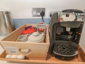 A coffee maker and a tray with a tea pot and tea bags at The Black Barnacle in Portreath