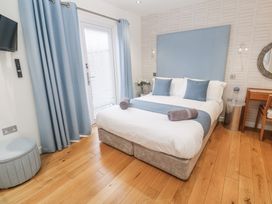 A bedroom with a bed and a window at The Black Barnacle in Portreath
