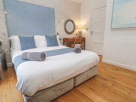 A bedroom with a bed and desk at The Black Barnacle in Portreath
