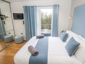A bedroom with a bed and television at The Black Barnacle in Portreath