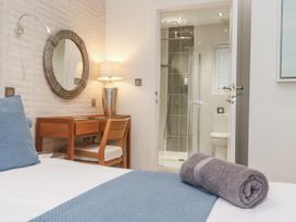 A bedroom with a bed and desk at The Black Barnacle Portreath