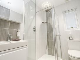 A bathroom with a shower, sink, and toilet at The Black Barnacle in Portreath
