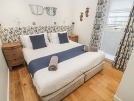 A bedroom with a bed and bedside tables at The Black Barnacle in Portreath