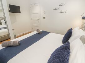 A bedroom with a bed and TV at The Black Barnacle Portreath