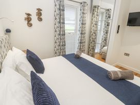 A bedroom with a bed and television at The Black Barnacle Portreath