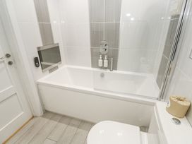 A bathroom with a bathtub and shower at The Black Barnacle Portreath