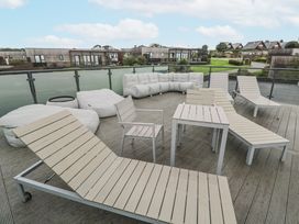 An outdoor seating area with chairs and cushions at The Black Barnacle in Portreath