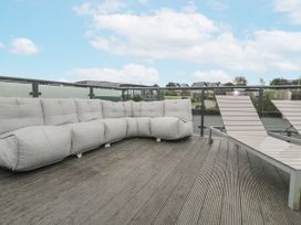 An outdoor space with a sofa and sun loungers at The Black Barnacle Portreath
