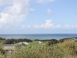 A view of the ocean and houses at The Black Barnacle Portreath