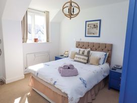 A bedroom with a bed and bedside table at Sea Shore in Seahouses