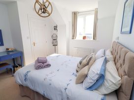A bedroom with a bed and a dressing table at Sea Shore in Seahouses