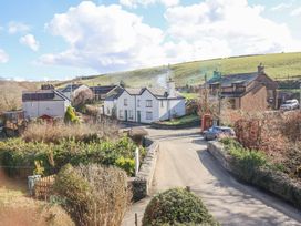 A rural village scene with houses cars hedges and a red telephone box at Minffordd in Pandy Tudur near Betws-Y-Coed