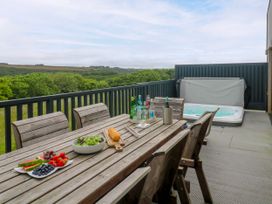 An outdoor dining area with a table and chairs at Dahlia in Portreath