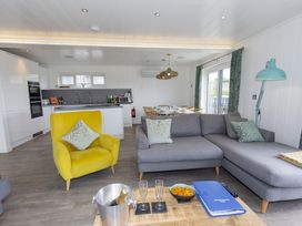A living room with a sofa and dining table at Dahlia in Portreath