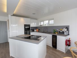 A kitchen with appliances and a countertop at Dahlia in Portreath