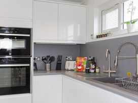 A kitchen with an oven and sink at Dahlia in Portreath