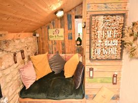 A snug area with cushions and a decorative sign at Petty Knowes Cottage Rochester near Otterburn