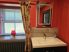 A bathroom with a sink and window at Petty Knowes Cottage Rochester near Otterburn