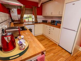 A kitchen with a kettle, toaster, and sink at Petty Knowes Cottage Rochester near Otterburn
