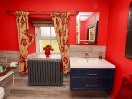 A bathroom with a sink and toilet at Petty Knowes Cottage in Rochester near Otterburn