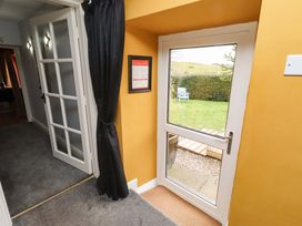 A hallway with a door leading to a garden at Petty Knowes Cottage Rochester near Otterburn