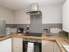 A kitchen with appliances and cooking space at Yeat Stoup Cottage in Cockermouth