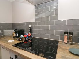 A kitchen with an induction hob and coffee machine at Yeat Stoup Cottage, Cockermouth