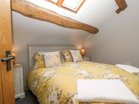 A bedroom with a bed and skylight at Yeat Stoup Cottage in Cockermouth