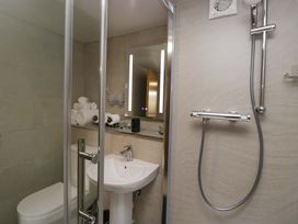 A bathroom with a shower, toilet, and sink at Yeat Stoup Cottage in Cockermouth