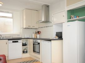 A kitchen with white cabinets appliances and a window at Alway in Lifton