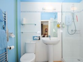 A bathroom with a toilet sink shower and towel rack at Alway in Lifton