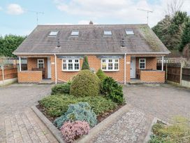A semi detached brick house with two white doors and windows a garden with bushes in front at Rooster in Stourport On Severn
