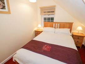 A bedroom with a double bed two bedside tables with lamps and a window with wooden blinds at Rooster in Stourport-On-Severn