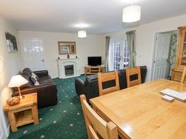 A living room with leather sofas television and dining table at Hen and Chickens in Stourport-On-Severn